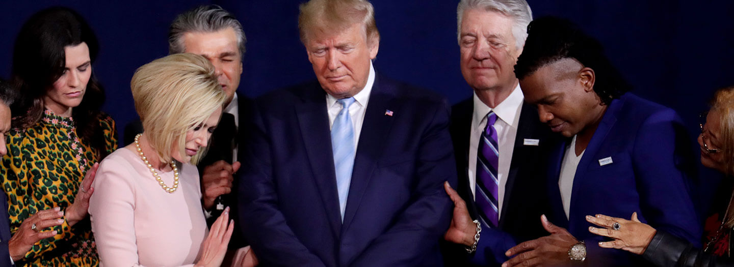 Pastor Paula White and other faith leaders pray with President Donald Trump
