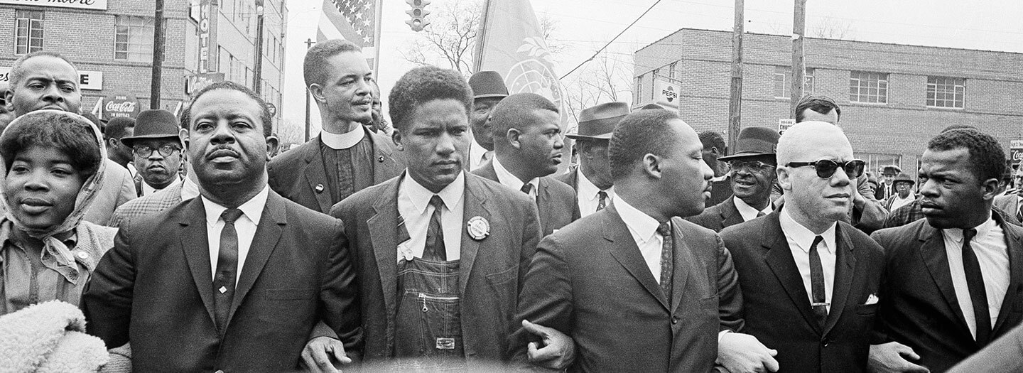 Dr. Martin Luther King King Jr., John Lewis, and others march to the courthouse in Montgomery, Alabama.