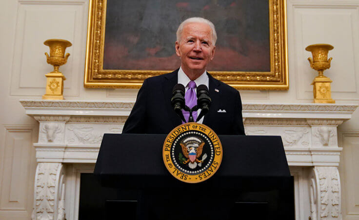 President Joe Biden arrives to speak about the coronavirus, accompanied by Vice President Kamala Harris, in the State Dinning Room of the White House, Thursday, Jan. 21, 2021.