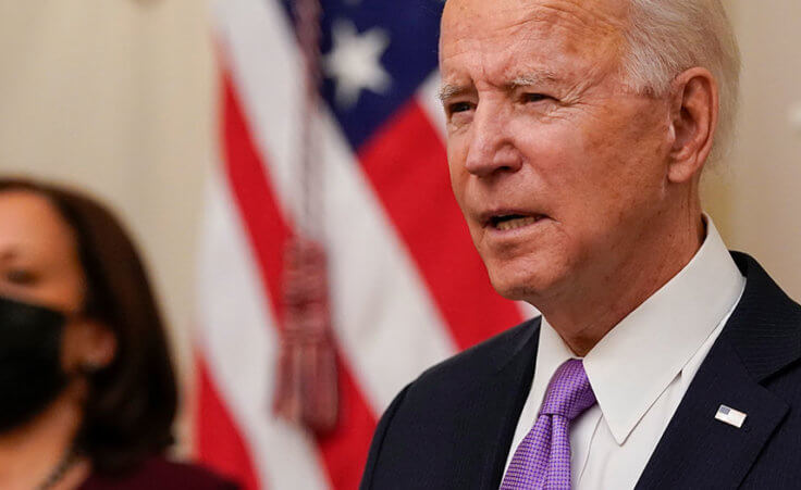 President Joe Biden speaks about the coronavirus, accompanied by Vice President Kamala Harris, in the State Dinning Room of the White House