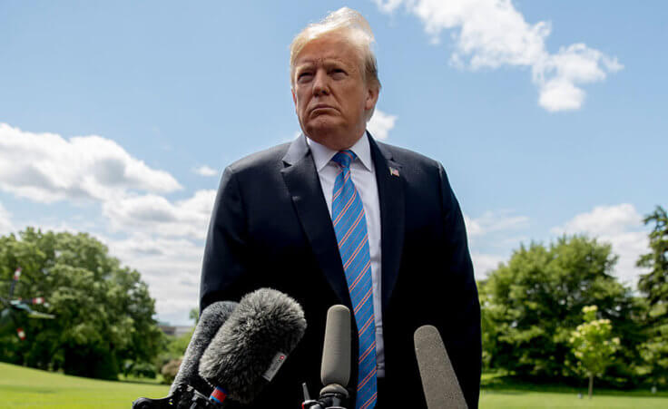 Donald Trump listens to a question from a member of the media