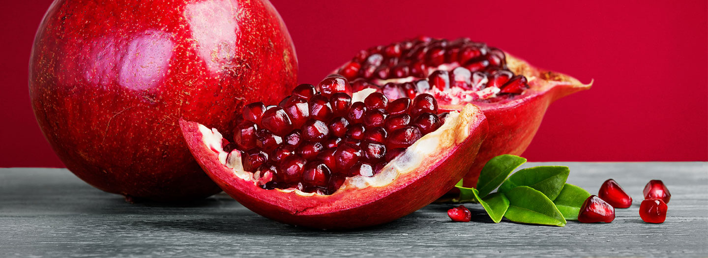 An open pomegranate revealing its red seeds
