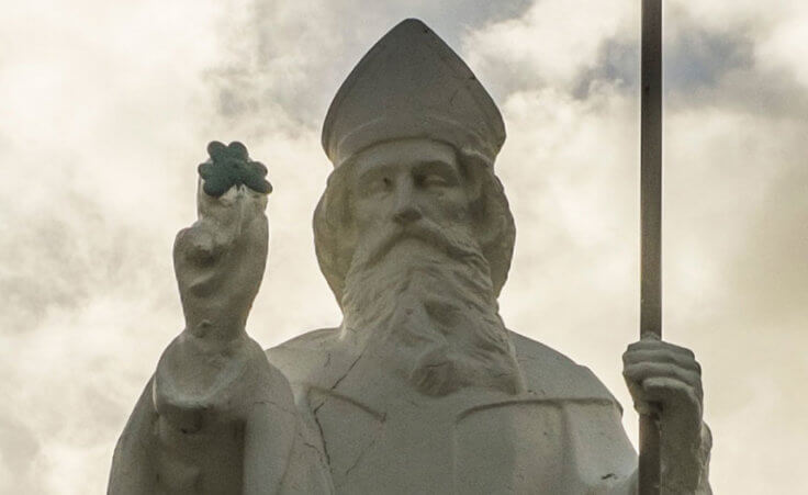 A statue of St. Patrick holding a shamrock