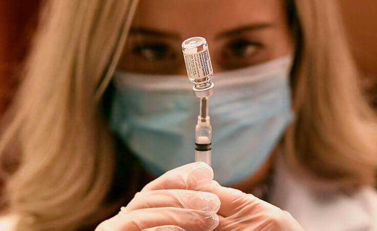 Pharmacist Madeline Acquilano draws a syringe of the Johnson & Johnson COVID-19 vaccine