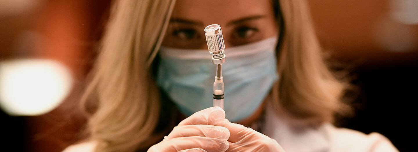Pharmacist Madeline Acquilano draws a syringe of the Johnson & Johnson COVID-19 vaccine