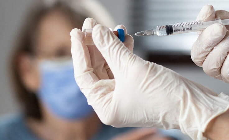 elderly woman getting coronavirus vaccine