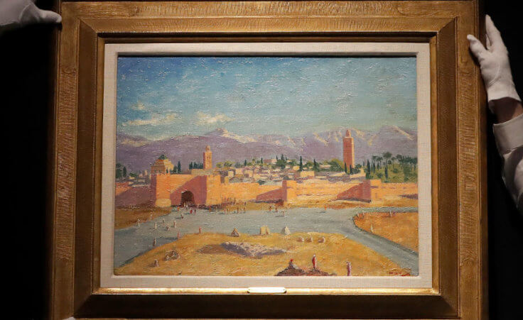 Christie's employees adjust an oil on canvas painting by Sir Winston Churchill painted in Jan. 1943 called 'Tower of the Koutoubia Mosque'