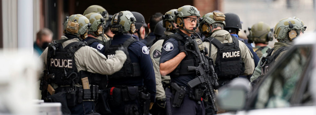 Police stand outside a King Soopers grocery store where authorities say multiple people have been killed in a shooting, Monday, March 22, 2021, in Boulder, Colo. (AP Photo/David Zalubowski)