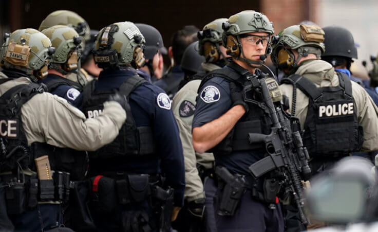 Police stand outside a King Soopers grocery store where authorities say multiple people have been killed in a shooting, Monday, March 22, 2021, in Boulder, Colo. (AP Photo/David Zalubowski)