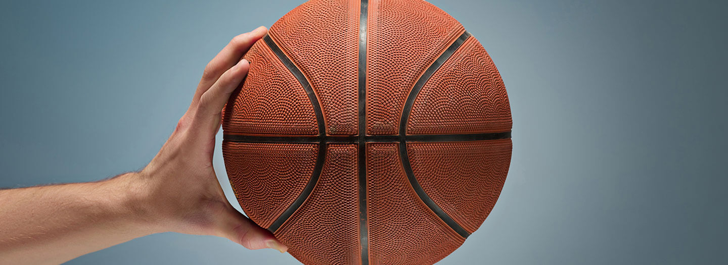 One hold holds out a basketball