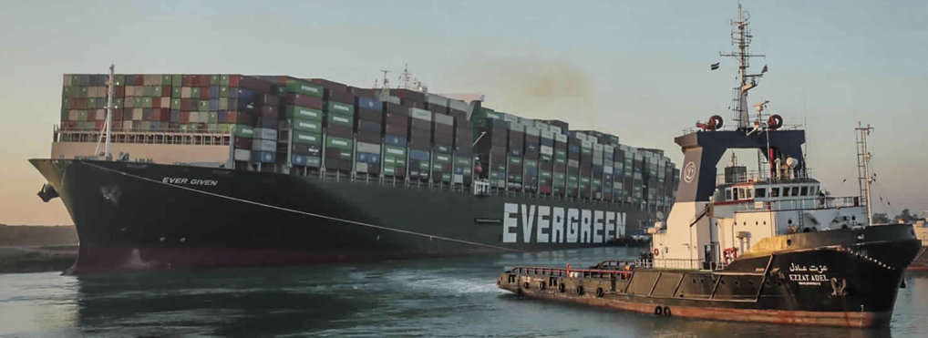 In this photo released by Suez Canal Authority, the Ever Given, a Panama-flagged cargo ship, is pulled by one of the Suez Canal tugboats, in the Suez Canal, Egypt, Monday, March 29, 2021. (Suez Canal Authority via AP)