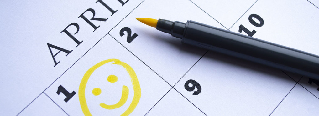 A yellow smiley face is drawn onto a calendar denoting April 1, aka April Fools' Day