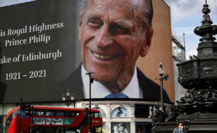 A tribute to Britain's Prince Philip is projected onto a large screen at Piccadilly Circus in London, Friday, April 9, 2021