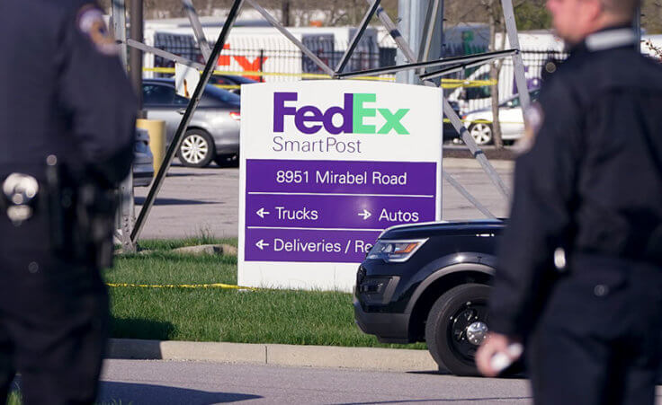 Police stand near the scene where multiple people were shot at the FedEx Ground facility early Friday morning, April 16, 2021, in Indianapolis. (AP Photo/Michael Conroy)