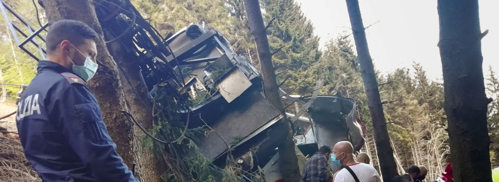 Rescuers work by the wreckage of a cable car after it collapsed near the summit of the Stresa-Mottarone line in the Piedmont region, northern Italy, Sunday, May 23, 2021. (Italian Police via AP)