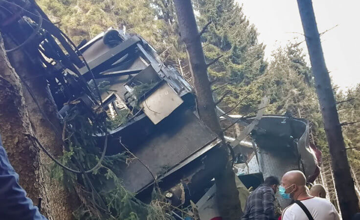 Rescuers work by the wreckage of a cable car after it collapsed near the summit of the Stresa-Mottarone line in the Piedmont region, northern Italy, Sunday, May 23, 2021. (Italian Police via AP)