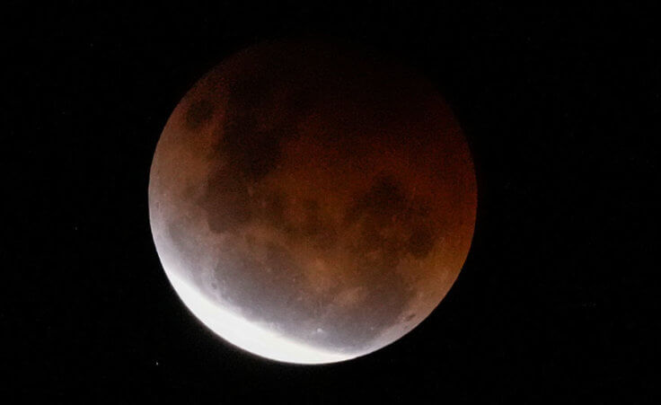 The Earth's shadow falls across the full moon above Sydney, Australia, Wednesday, May 26, 2021.