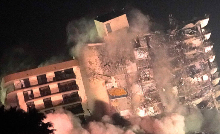 The remaining structure of the Champlain Towers South condo building is demolished more than a week after it partially collapsed, Sunday, July 4, 2021, in Surfside, Fla. (AP Photo/Lynne Sladky)