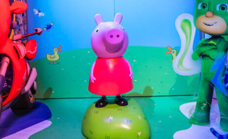 A Peppa Pig model stands between models of Ricky Zoom and PJ Masks.