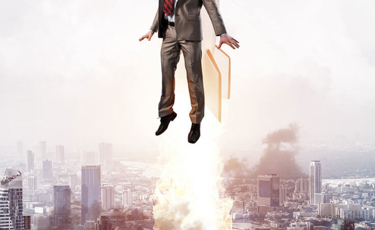 A man with a jetpack flies into the air above skyscrapers