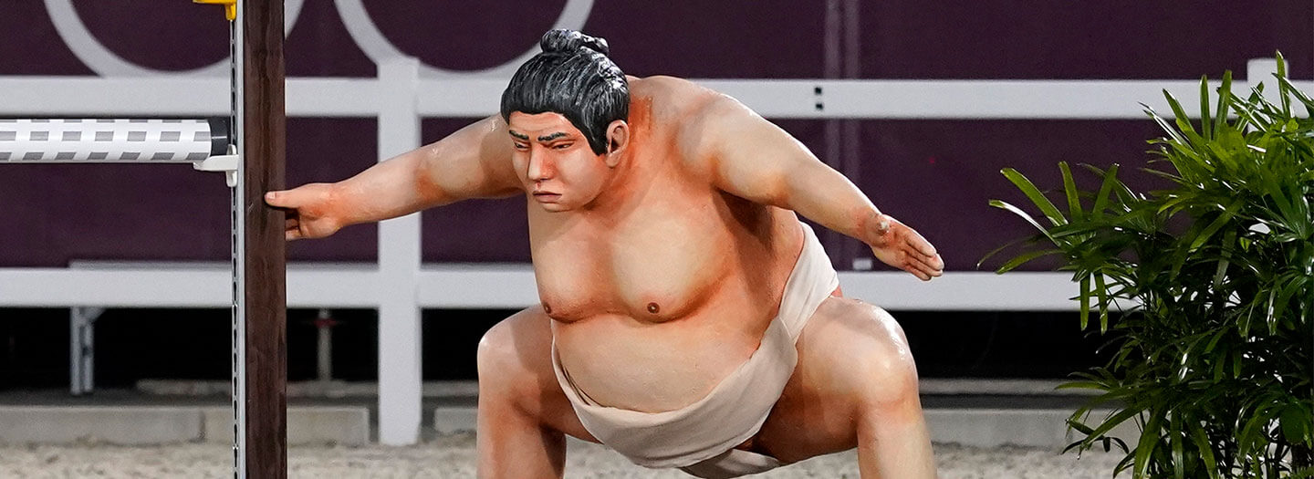 closeup of sumo wrestling statue at equestrian Olympics event