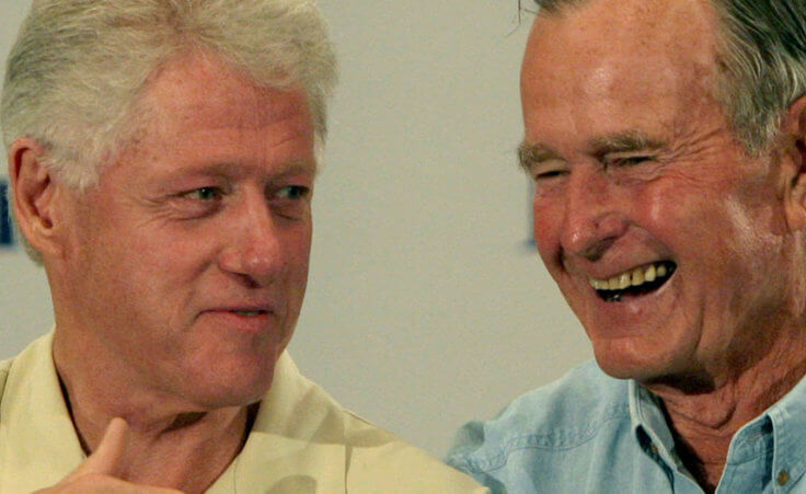 Former Presidents Bill Clinton, left, and George H.W. Bush joke during a press conference in Houston Monday, Sept. 5, 2005, before meeting with Hurricane Katrina refugees.