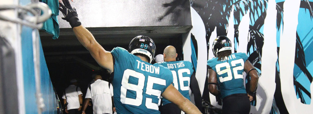 Jacksonville Jaguars tight end Tim Tebow (85) high fives fans after an NFL preseason football game against the Cleveland Browns, Saturday, Aug. 14, 2021, in Jacksonville, Fla. (AP Photo/Stephen B. Morton)
