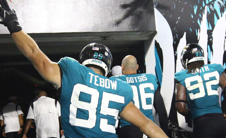 Jacksonville Jaguars tight end Tim Tebow (85) high fives fans after an NFL preseason football game against the Cleveland Browns, Saturday, Aug. 14, 2021, in Jacksonville, Fla. (AP Photo/Stephen B. Morton)