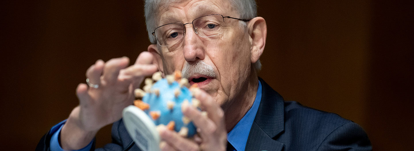 Dr. Francis Collins, Director of the National Institutes of Health (NIH), holds up a model of COVID-19, known as coronavirus, during a Senate Appropriations subcommittee hearing on the plan to research, manufacture and distribute a coronavirus vaccine, known as Operation Warp Speed, Thursday, July 2, 2020, on Capitol Hill in Washington. (Saul Loeb/Pool via AP)