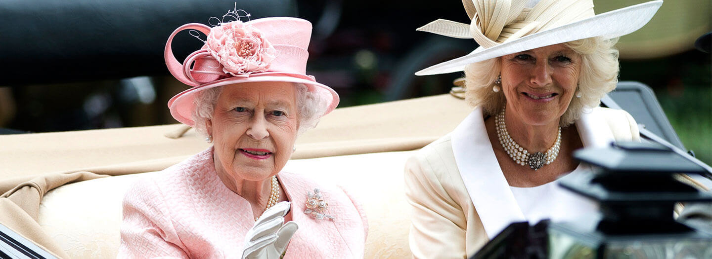 FILE - Britain's Queen Elizabeth II waves to the crowds with Camilla, Duchess of Cornwall at right, as they arrive by carriage on the first day of the Royal Ascot horse race meeting in Ascot, England, Tuesday, June 18, 2013. (AP Photo/Alastair Grant, File)