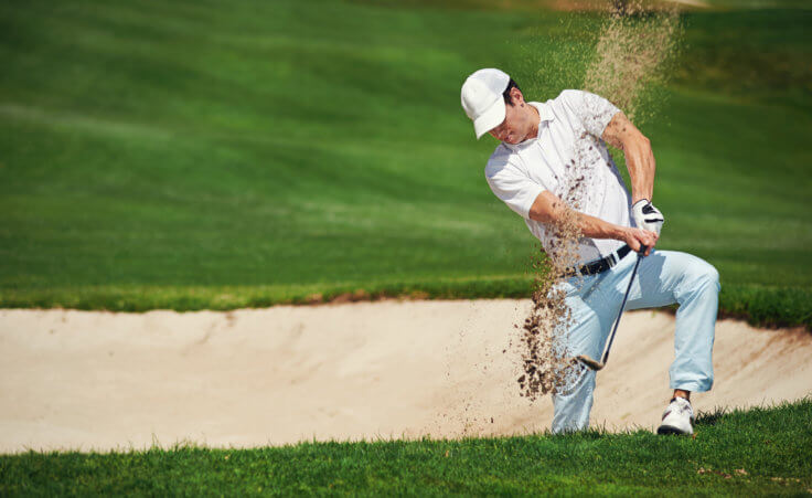 golf shot from sand bunker golfer hitting ball from hazard