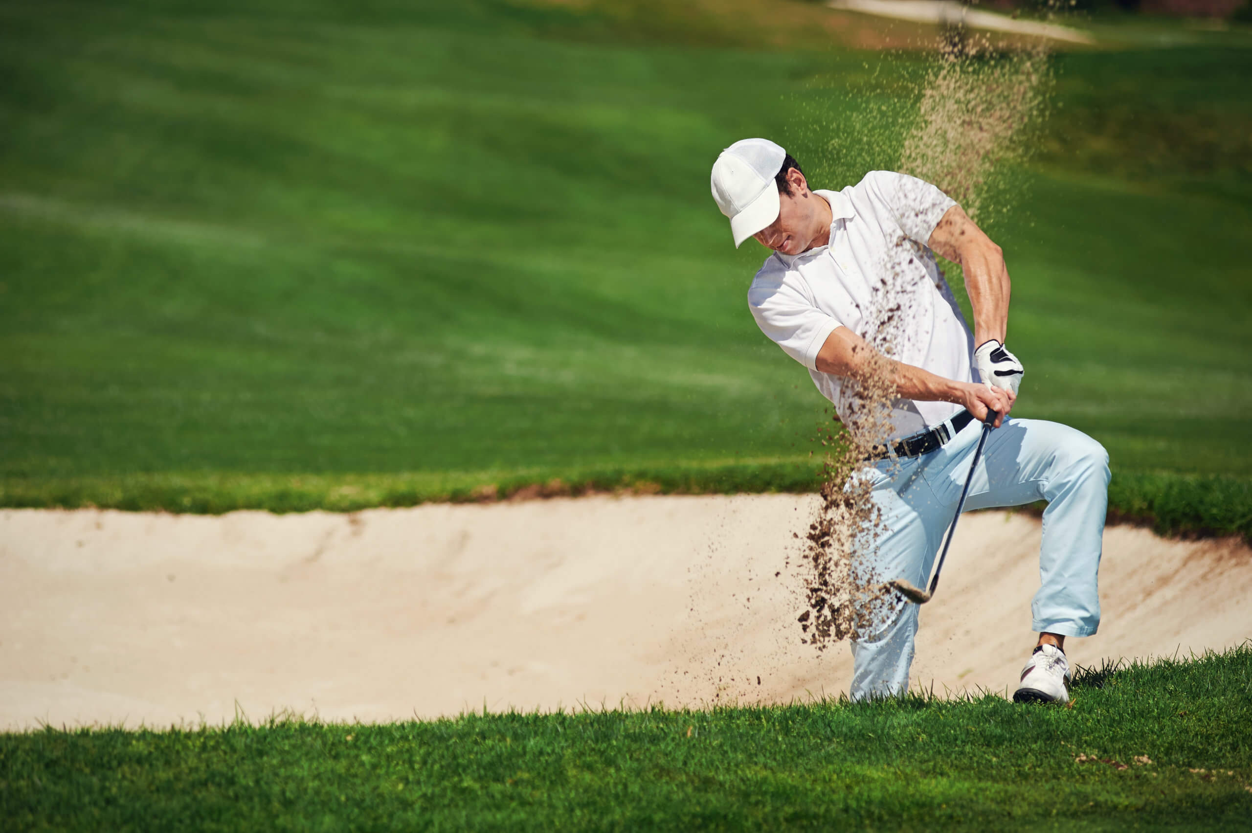 golf shot from sand bunker golfer hitting ball from hazard