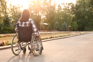 Young woman in wheelchair outdoors