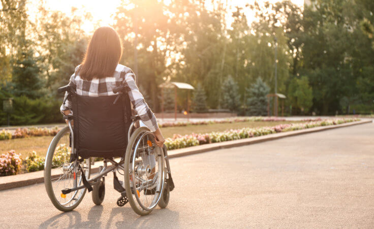 Young woman in wheelchair outdoors