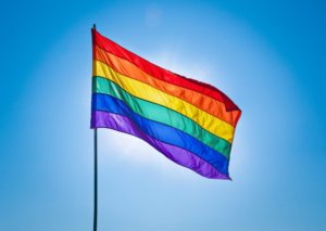 A gay pride flag flies in front of a blue sky. © Alexander Demyanenko/stock.adobe.com. As it's a divisive issue in Christianity, many people wonder, "What does the Bible say about homosexuality?"