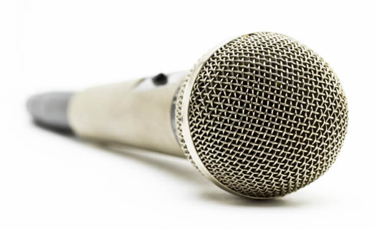 A silver studio microphone on a white background