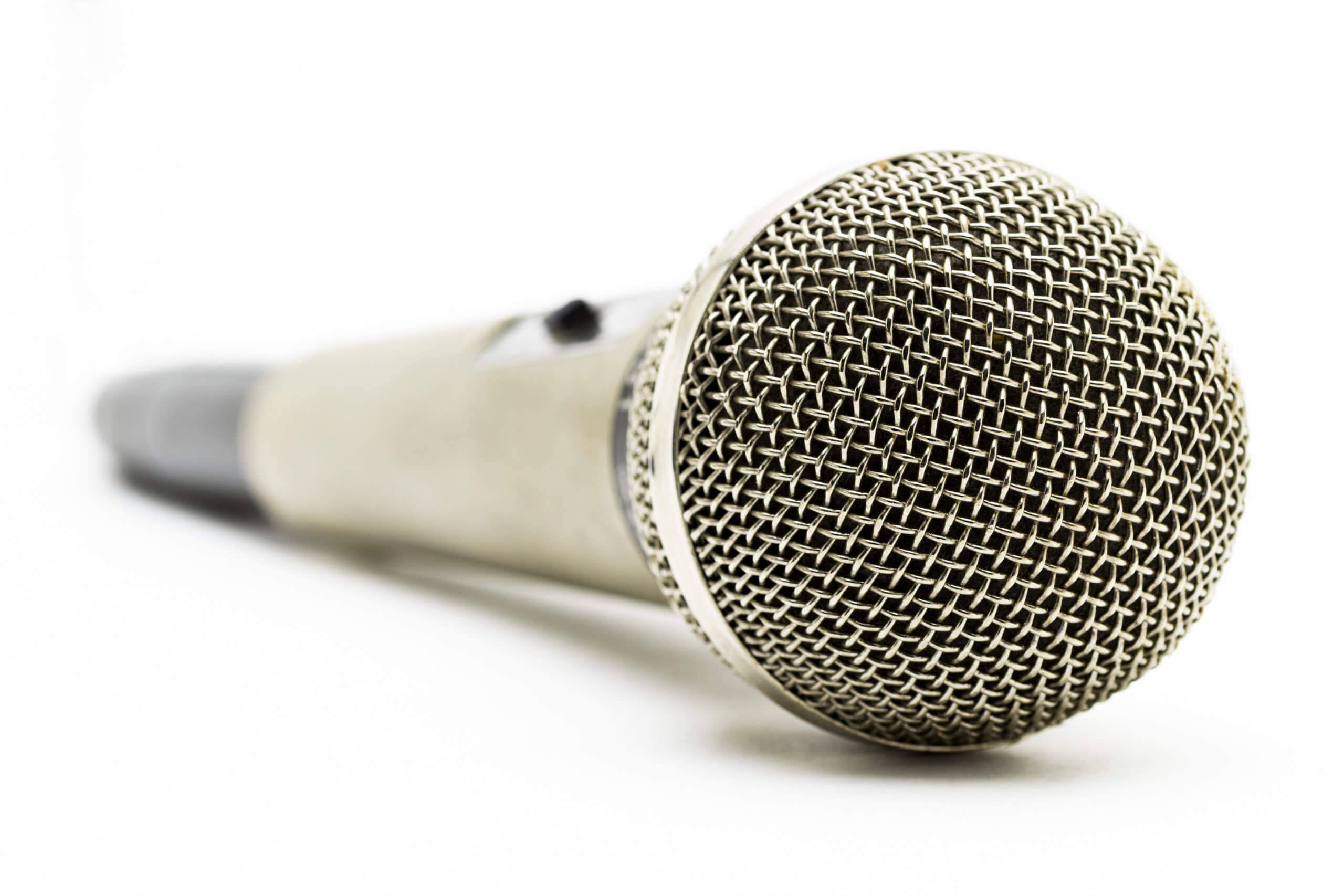 A silver studio microphone on a white background