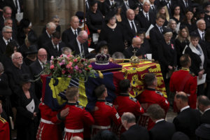 Britain's Queen Elizabeth's coffin is carried inside the Westminster Abbey, during her funeral in London, Monday Sept. 19, 2022. (Phil Noble/Pool Photo via AP)