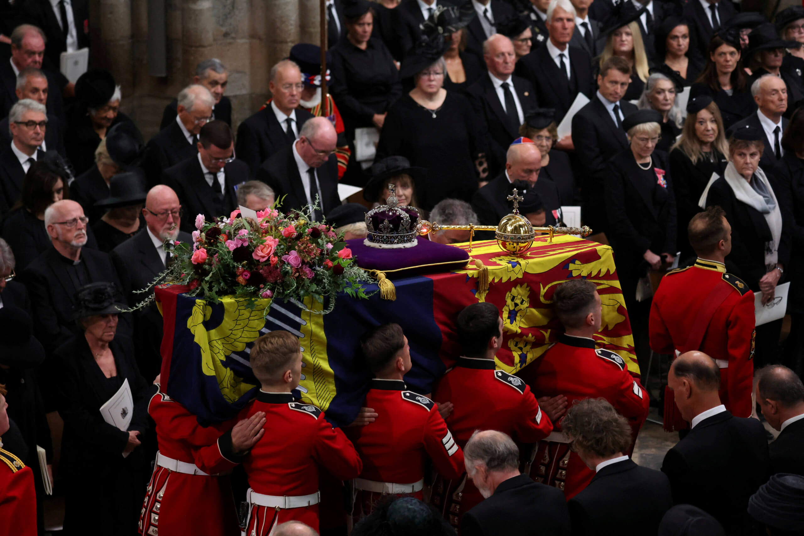 Britain's Queen Elizabeth's coffin is carried inside the Westminster Abbey, during her funeral in London, Monday Sept. 19, 2022. (Phil Noble/Pool Photo via AP)