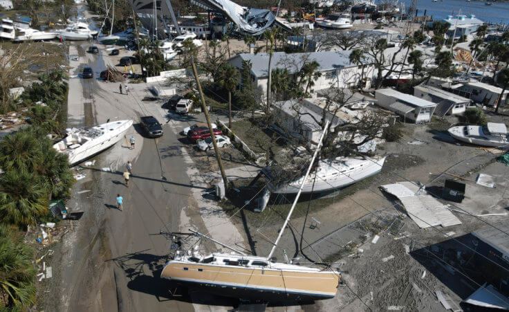 In this photo taken by a drone, boats lie scattered amidst mobile homes after the passage of Hurricane Ian, on San Carlos Island, in Fort Myers Beach, Fla., Thursday, Sept. 29, 2022. (AP Photo/Rebecca Blackwell)