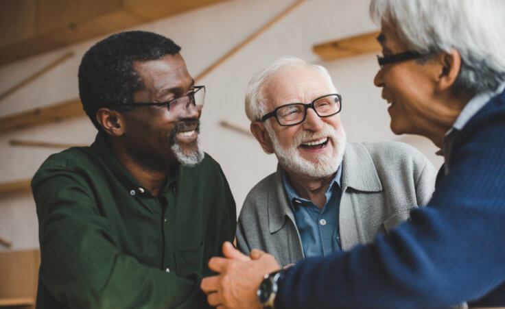 A multicultural group of three senior adult men laugh with each other. © LIGHTFIELD STUDIOS /stock.adobe.com