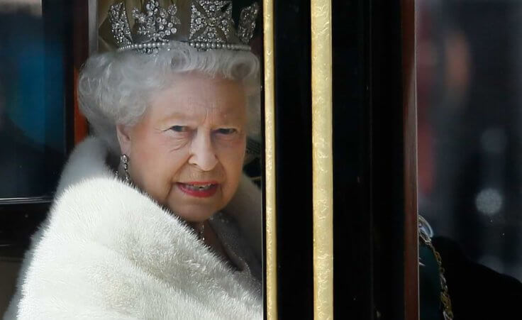 Britain's Queen Elizabeth II travels in a carriage from Buckingham Palace towards the Houses of Parliament in London, Wednesday, May 27, 2015. The Queen will deliver a speech to open Britain's Parliament after the new Conservative government was elected. (AP Photo/Kirsty Wigglesworth)