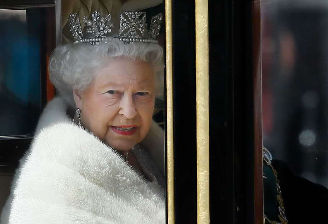 Britain's Queen Elizabeth II travels in a carriage from Buckingham Palace towards the Houses of Parliament in London, Wednesday, May 27, 2015. The Queen will deliver a speech to open Britain's Parliament after the new Conservative government was elected. (AP Photo/Kirsty Wigglesworth)