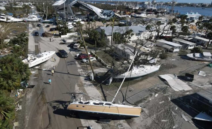 In this photo taken by a drone, boats lie scattered amidst mobile homes after the passage of Hurricane Ian, on San Carlos Island, in Fort Myers Beach, Fla., Thursday, Sept. 29, 2022. (AP Photo/Rebecca Blackwell)