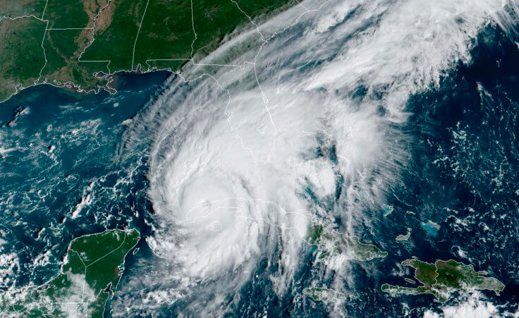 This GOES-East GeCcolor satellite image taken at 9:56 a.m. EDT on Tuesday, Sept. 27, 2022, and provided by the National Oceanic and Atmospheric Administration (NOAA), shows Hurricane Ian passing over western Cuba. Hurricane Ian tore into western Cuba on Tuesday as a major hurricane, with nothing to stop it from intensifying into a catastrophic Category 4 storm before it hits Florida, where officials ordered 2.5 million people to evacuate before it crashes ashore Wednesday. (NOAA via AP )