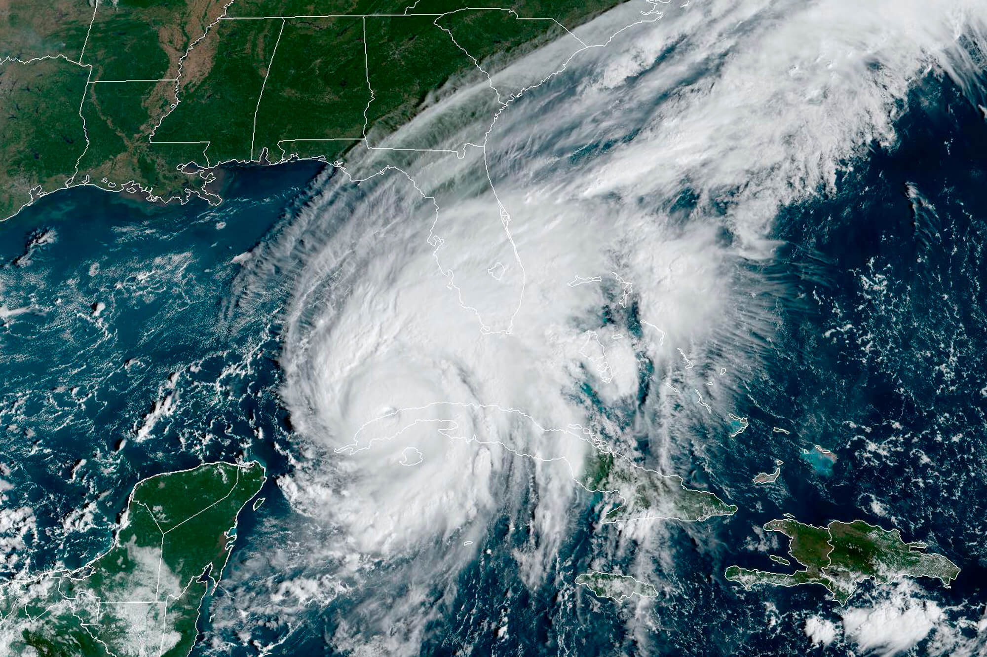 This GOES-East GeCcolor satellite image taken at 9:56 a.m. EDT on Tuesday, Sept. 27, 2022, and provided by the National Oceanic and Atmospheric Administration (NOAA), shows Hurricane Ian passing over western Cuba. Hurricane Ian tore into western Cuba on Tuesday as a major hurricane, with nothing to stop it from intensifying into a catastrophic Category 4 storm before it hits Florida, where officials ordered 2.5 million people to evacuate before it crashes ashore Wednesday. (NOAA via AP )