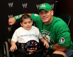 In this Monday, June 18, 2012 photo, seven-year old, Jonny Littman, poses with WWE superstar, John Cena, at the 300th Make-A-Wish for Cena in Uniondale, N.Y. It was the 300th wish granted by Cena, making him the most popular celebrity granter in Make-A-Wish history. (AP Photo/John Carucci)