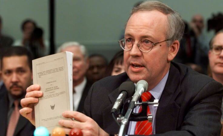 FILE - Independent Counsel Kenneth Starr holds a copy of his report while testifying on Capitol Hill Thursday Nov. 19, 1998, before the House Judiciary Committee's impeachment hearing. Starr, whose criminal investigation of Bill Clinton led to the president’s impeachment, died Sept. 13, 2022. He was 76. (AP Photo/Doug Mills, File)