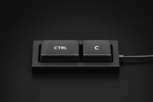 A stock photo shows a two-key keyboard containing only button for Ctrl and C, the shortcut used for copying--and an illustration of plagiarism. © Lemonsoup14/stock.adobe.com