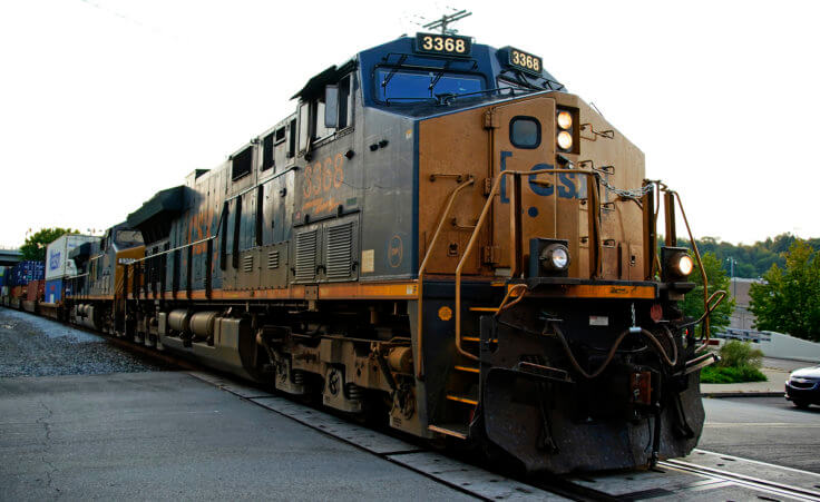A CSX freight train runs through a crossing in Homestead, Pa., on Wednesday, Sept. 14, 2022. (AP Photo/Gene J. Puskar)